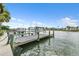 Waterfront dock with boat lift, providing convenient access to the water at 241 176Th Terrace E Dr, Redington Shores, FL 33708