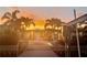 Sunset view of patio home, dock and waterfront at 241 176Th Terrace E Dr, Redington Shores, FL 33708