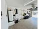 Spacious garage featuring epoxy flooring and storage racks, offering ample space for vehicles and equipment at 241 176Th Terrace E Dr, Redington Shores, FL 33708