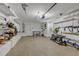 Spacious garage with storage shelving, equipment and neutral carpeting at 241 176Th Terrace E Dr, Redington Shores, FL 33708