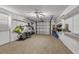 Spacious garage with storage shelving and neutral carpeting at 241 176Th Terrace E Dr, Redington Shores, FL 33708