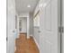 Hallway featuring beautiful terracotta-tiled floors with white doors and trim, offering a bright and clean aesthetic at 241 176Th Terrace E Dr, Redington Shores, FL 33708