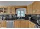 Kitchen with stone countertops, stainless steel appliances, and wood cabinets at 241 176Th Terrace E Dr, Redington Shores, FL 33708