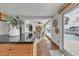 Bright kitchen and dining area leading to a pool view through sliding glass doors, with granite countertops at 241 176Th Terrace E Dr, Redington Shores, FL 33708