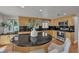 Spacious kitchen with stone countertops, a central island, wood cabinets, and stainless steel appliances at 241 176Th Terrace E Dr, Redington Shores, FL 33708