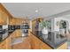 Spacious kitchen with stone countertops, wood cabinets, and stainless steel appliances at 241 176Th Terrace E Dr, Redington Shores, FL 33708