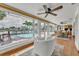The living room boasts water views, a cozy seating area, and outdoor access to the pool and patio at 241 176Th Terrace E Dr, Redington Shores, FL 33708