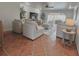 Living room features tile floors, a modern ceiling fan, and neutral furniture at 241 176Th Terrace E Dr, Redington Shores, FL 33708