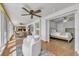 Open-concept living room with ceiling fan with views of bedroom and kitchen/dining areas through arched doorway at 241 176Th Terrace E Dr, Redington Shores, FL 33708