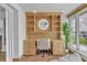 Bright office with stylish built-in shelving and desk with view to waterfront through a large window at 241 176Th Terrace E Dr, Redington Shores, FL 33708