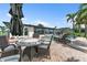 Outdoor patio with wicker furniture, dark umbrella, and brick-paved pool area at 241 176Th Terrace E Dr, Redington Shores, FL 33708