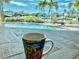 Relaxing pool view through a window, showcasing the waterfront and a chair, perfect for coffee and contemplation at 241 176Th Terrace E Dr, Redington Shores, FL 33708