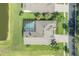 Aerial view of home with screened pool near pond, lush landscaping, and a brick driveway at 27528 Water Ash Dr, Wesley Chapel, FL 33544