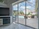 Bright living room showcasing a view of the backyard swimming pool and patio at 27528 Water Ash Dr, Wesley Chapel, FL 33544