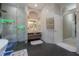 The bathroom features a shower with black and white marble, floating vanity and heated towel rack at 27528 Water Ash Dr, Wesley Chapel, FL 33544