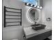 Close up of bathroom with dark fixtures and circular lighting at 27528 Water Ash Dr, Wesley Chapel, FL 33544