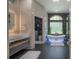 Lavish bathroom featuring a freestanding tub, floating marble vanity, and a doorway to the commode at 27528 Water Ash Dr, Wesley Chapel, FL 33544