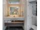 Bright bathroom features a marble vanity, illuminated mirror, and open doorway to the commode at 27528 Water Ash Dr, Wesley Chapel, FL 33544