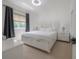 Bright bedroom featuring white furniture set and neutral carpet, offering a peaceful retreat at 27528 Water Ash Dr, Wesley Chapel, FL 33544