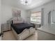 Comfortable bedroom with a silver bed frame and matching furniture at 27528 Water Ash Dr, Wesley Chapel, FL 33544
