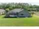 Aerial view of home with screened-in pool, green lawn, and a serene backyard setting at 27528 Water Ash Dr, Wesley Chapel, FL 33544
