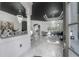 Bright foyer featuring modern chandelier, tiled floors, and access to other living areas at 27528 Water Ash Dr, Wesley Chapel, FL 33544