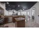 Modern kitchen featuring an island, stainless steel appliances, and a view of the living area at 27528 Water Ash Dr, Wesley Chapel, FL 33544