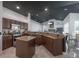 Spacious kitchen features stainless steel appliances, dark cabinets and granite countertops at 27528 Water Ash Dr, Wesley Chapel, FL 33544