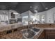 Gourmet kitchen overlooking the living room and pool with granite countertops and stainless steel sink at 27528 Water Ash Dr, Wesley Chapel, FL 33544