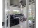 The living room features contemporary decor, a modern chandelier, and a view of the beautiful pool area at 27528 Water Ash Dr, Wesley Chapel, FL 33544