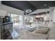 Open-concept living room with plush white sofas, marble tiled flooring, and lots of natural light at 27528 Water Ash Dr, Wesley Chapel, FL 33544