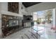 Living room featuring a marble tiled fireplace and a beautiful view of the backyard swimming pool at 27528 Water Ash Dr, Wesley Chapel, FL 33544