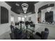 Living area with modern chandelier, an adjacent dining room, and access to the backyard at 27528 Water Ash Dr, Wesley Chapel, FL 33544