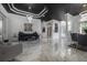 Living space showcasing marble tiled floors, a modern chandelier, and an adjacent living space at 27528 Water Ash Dr, Wesley Chapel, FL 33544