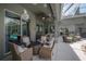 Covered outdoor patio with stylish seating arrangements and view of the pool and backyard at 27528 Water Ash Dr, Wesley Chapel, FL 33544