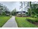 Shaded playground area with various play structures, picnic tables, and green space for enjoyment at 27528 Water Ash Dr, Wesley Chapel, FL 33544