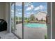 An inviting, enclosed outdoor pool with clear blue water at 27528 Water Ash Dr, Wesley Chapel, FL 33544