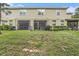 The home has a spacious backyard with a lawn, a screened lanai, and access to a wooded area at 2844 Jacob Crossing Ln, Holiday, FL 34691