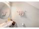 This half bath has a sink, toilet, mirror, and a towel rack at 2844 Jacob Crossing Ln, Holiday, FL 34691