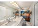 This bathroom features a double sink vanity and shower with ocean themed curtain at 2844 Jacob Crossing Ln, Holiday, FL 34691