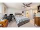 This bedroom features a ceiling fan, a bed, and an adjacent bathroom at 2844 Jacob Crossing Ln, Holiday, FL 34691
