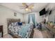 This bedroom features a light colored bed with blue accents and a ceiling fan at 2844 Jacob Crossing Ln, Holiday, FL 34691