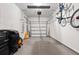 Spacious garage with epoxy floor, storage, and bike rack at 2844 Jacob Crossing Ln, Holiday, FL 34691