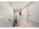 This hallway features carpet flooring, a linen closet and a view of the stairway at 2844 Jacob Crossing Ln, Holiday, FL 34691