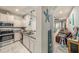Modern kitchen with stainless steel appliances, granite countertops, and seamless access to the living room at 2844 Jacob Crossing Ln, Holiday, FL 34691