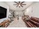 Cozy living room with a fan, access to the outdoor patio, and seamless flow to the kitchen at 2844 Jacob Crossing Ln, Holiday, FL 34691