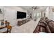 Spacious living room with tile floors, large TV, access to outdoor patio, and ceiling fan at 2844 Jacob Crossing Ln, Holiday, FL 34691