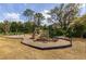 Neighborhood playground with slides, swings, and wood chip ground covering at 2844 Jacob Crossing Ln, Holiday, FL 34691