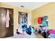 This bedroom features a closet, yellow walls, and a door at 306 Brandywine Dr, Valrico, FL 33594