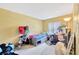 Bedroom with carpeting, yellow walls, and large window at 306 Brandywine Dr, Valrico, FL 33594